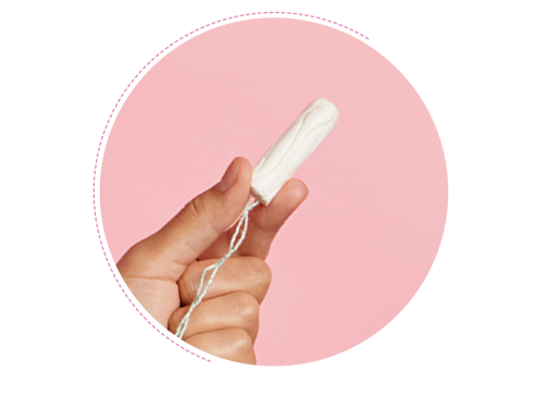 A hand holding a clean tampon against a pink backdrop.